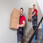 two-male-movers-walking-downward-boxes-staircase-portrait-young-uniform-carrying-cardboard-182283752